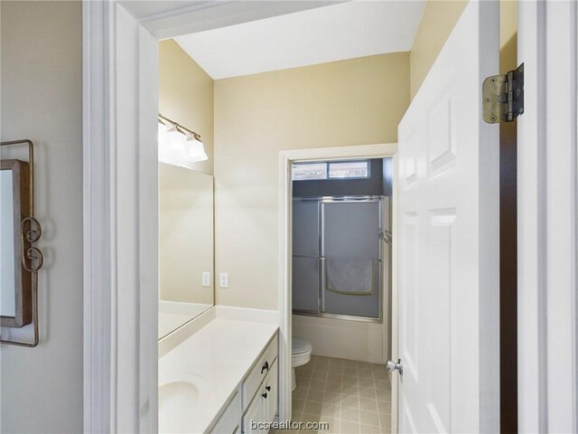 full bathroom with vanity, toilet, and bath / shower combo with glass door