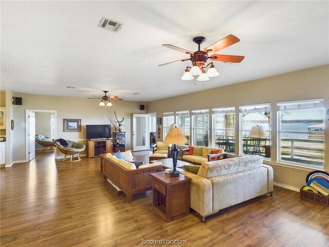 living room featuring ceiling fan and dark hardwood / wood-style flooring