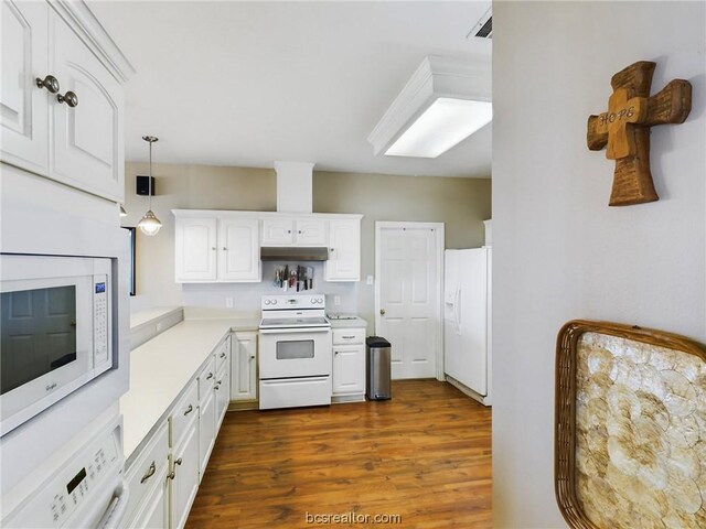 kitchen featuring white cabinetry, dark hardwood / wood-style floors, washer / clothes dryer, white appliances, and decorative light fixtures