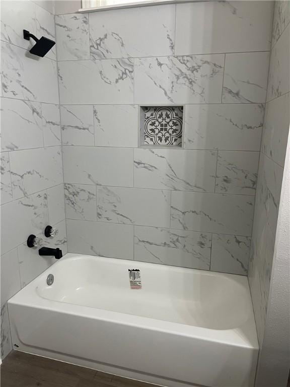 bathroom featuring hardwood / wood-style floors and tiled shower / bath