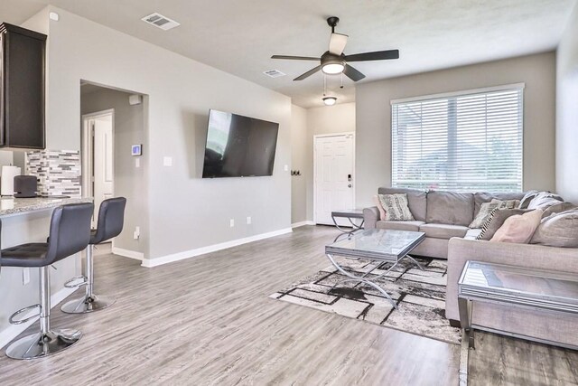 107 Meadow Lake Ct, Navasota, TX 77868 - living area featuring wood finished floors, a ceiling fan, and baseboards