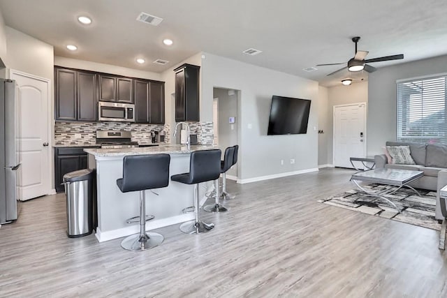 107 Meadow Lake Ct, Navasota, TX 77868 - kitchen with stainless steel appliances, open floor plan, ceiling fan, light wood-type flooring, and recessed lighting
