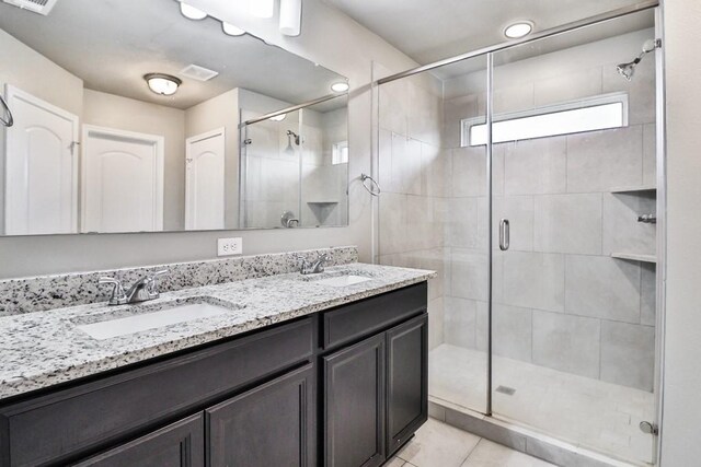 107 Meadow Lake Ct, Navasota, TX 77868 - bathroom with a stall shower, double vanity, and tile patterned floors