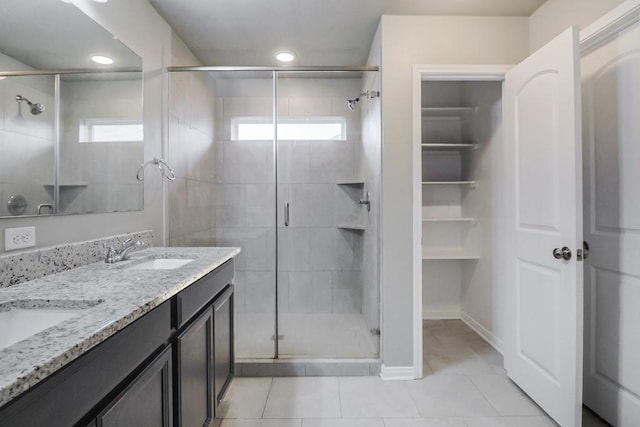107 Meadow Lake Ct, Navasota, TX 77868 - bathroom with a stall shower, tile patterned floors, and double vanity