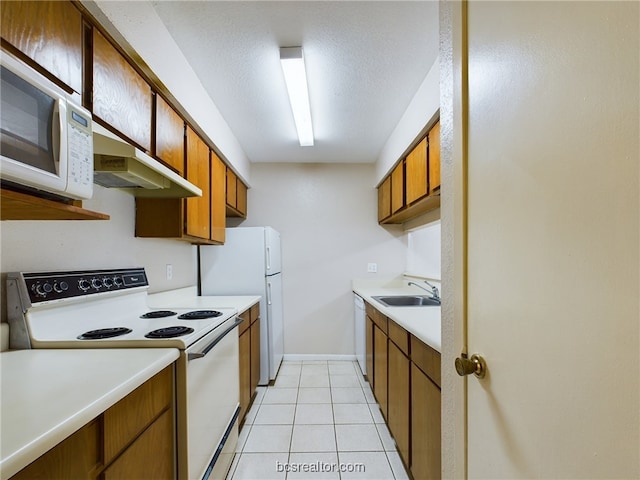 kitchen with sink, light tile patterned flooring, and white appliances