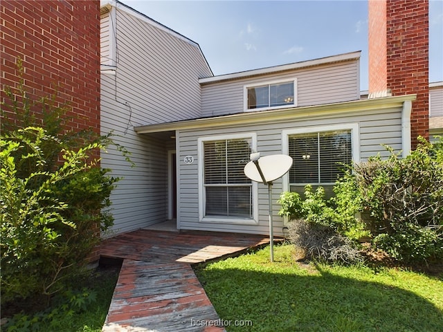 rear view of property with a lawn