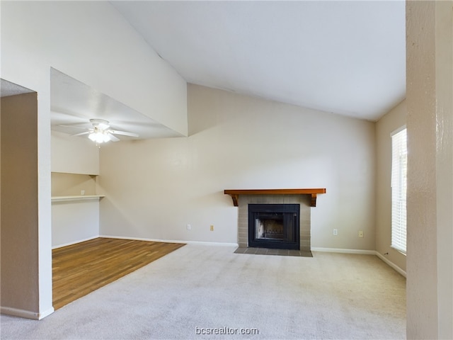 unfurnished living room with light colored carpet, vaulted ceiling, and ceiling fan