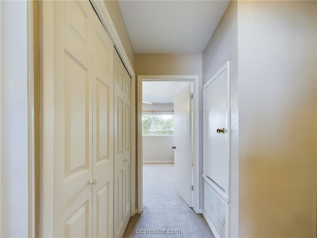 corridor featuring light colored carpet