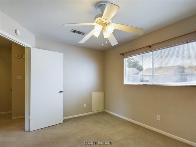 carpeted empty room featuring ceiling fan