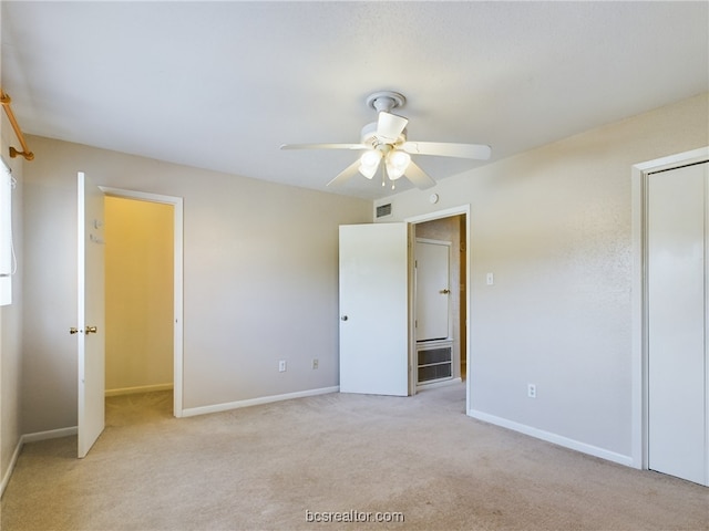 unfurnished bedroom with ceiling fan and light colored carpet