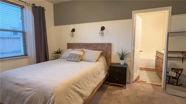 301 Pine Mist Ln, Conroe, TX 77304 - bedroom featuring a decorative wall, a wainscoted wall, carpet floors, and connected bathroom