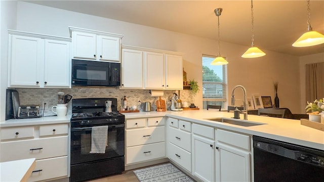 301 Pine Mist Ln, Conroe, TX 77304 - kitchen featuring black appliances, light countertops, tasteful backsplash, and white cabinets