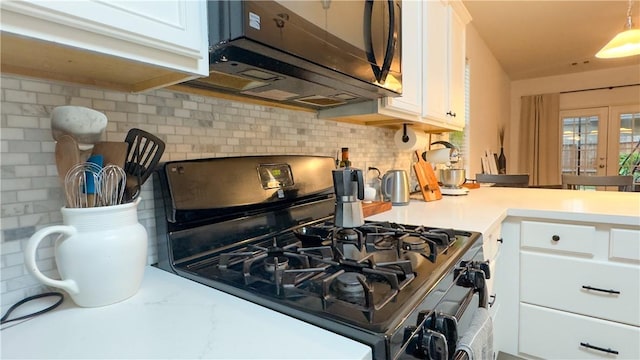 301 Pine Mist Ln, Conroe, TX 77304 - kitchen with gas range oven, stainless steel microwave, light countertops, and white cabinets