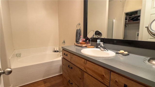 301 Pine Mist Ln, Conroe, TX 77304 - bathroom with a bath, vanity, and wood finished floors