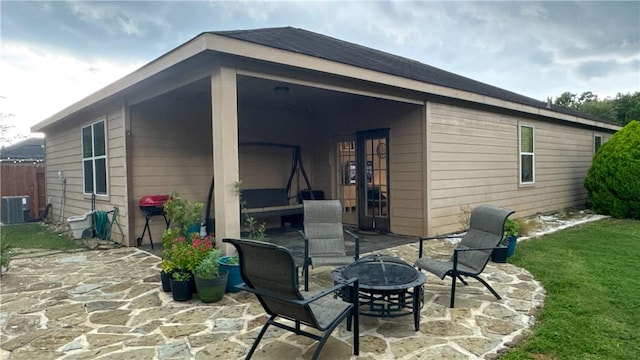 301 Pine Mist Ln, Conroe, TX 77304 - rear view of property with a fire pit and a patio