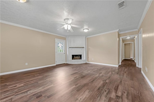 1503 Tara Ct, College Station, TX 77840 - unfurnished living room featuring a textured ceiling, ceiling fan, dark wood-style floors, a fireplace, and crown molding