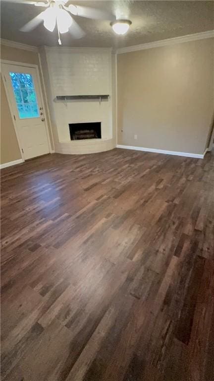 1503 Tara Ct, College Station, TX 77840 - unfurnished living room featuring a fireplace, ornamental molding, ceiling fan, and dark wood finished floors