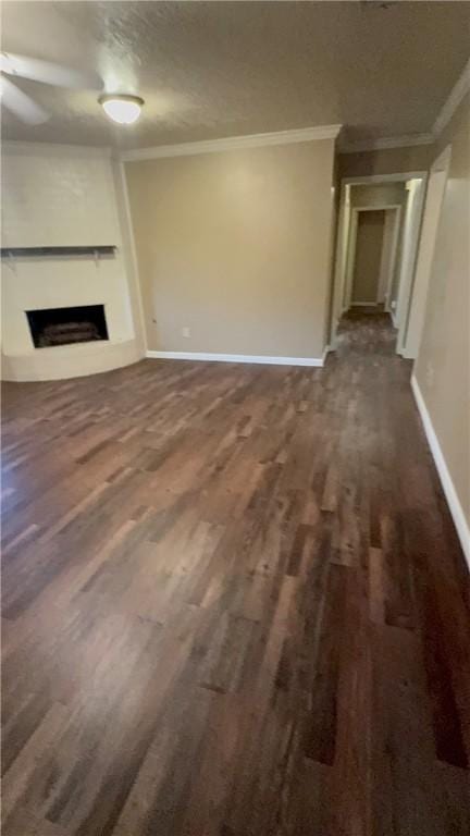 1503 Tara Ct, College Station, TX 77840 - unfurnished living room featuring ornamental molding, dark wood finished floors, a fireplace, and ceiling fan