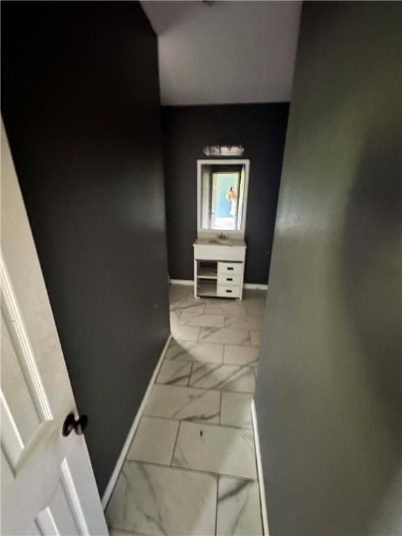 1113 W 10th St, Hearne, TX 77859 - hallway featuring marble finish floors and baseboards