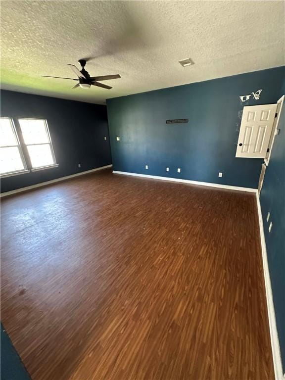 1113 W 10th St, Hearne, TX 77859 - spare room with ceiling fan, wood finished floors, and a textured ceiling