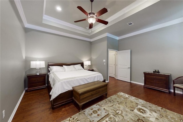 bedroom featuring a raised ceiling, ornamental molding, and dark hardwood / wood-style floors