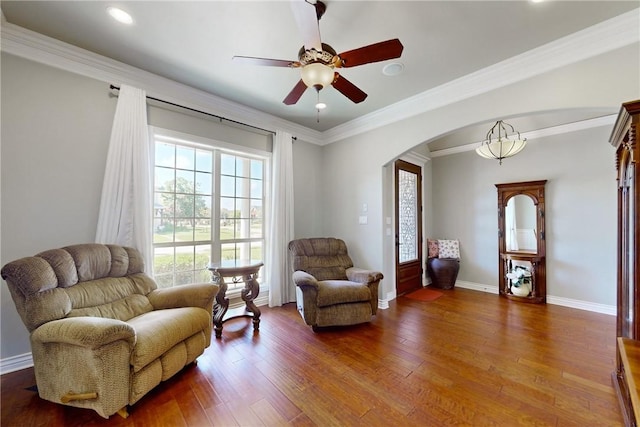 living area with crown molding, ceiling fan, and hardwood / wood-style floors