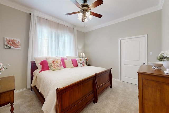 carpeted bedroom with ornamental molding and ceiling fan