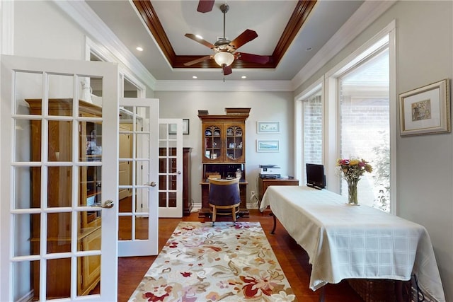 office with french doors, ornamental molding, dark hardwood / wood-style flooring, a raised ceiling, and ceiling fan