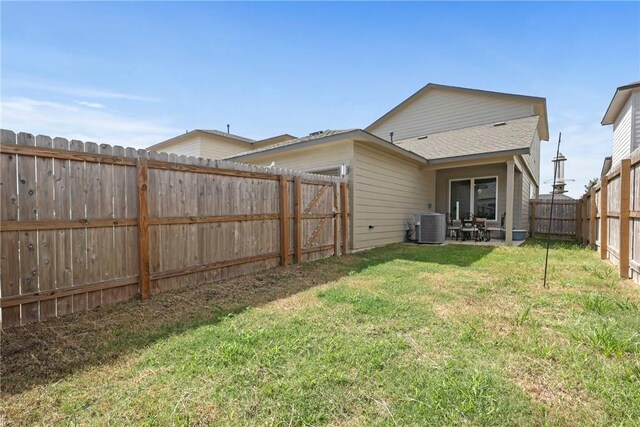 1121 Amistad Loop, College Station, TX 77845 - back of property featuring a fenced backyard, a patio area, and roof with shingles