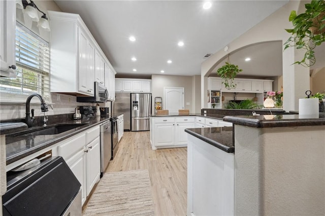 740 Bridget Ave, Buffalo, TX 75831 - kitchen featuring light wood-style floors, recessed lighting, stainless steel appliances, white cabinets, and decorative backsplash
