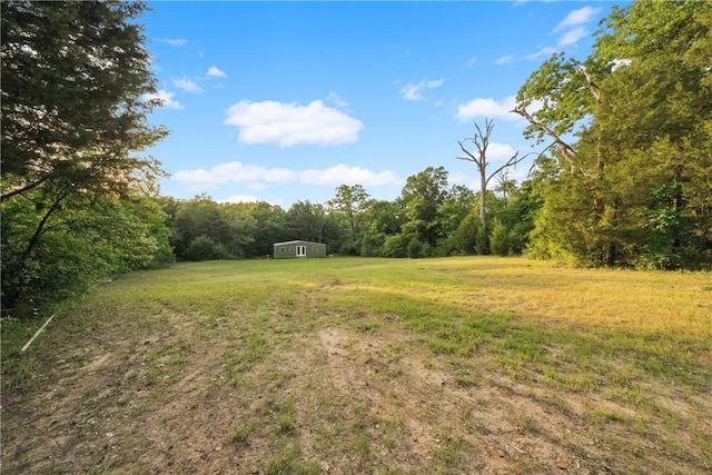 740 Bridget Ave, Buffalo, TX 75831 - view of grassy yard featuring a wooded view and an outdoor structure