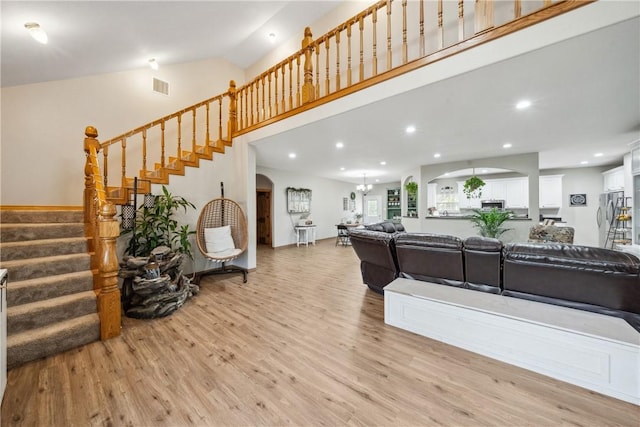 740 Bridget Ave, Buffalo, TX 75831 - living room featuring arched walkways, light wood finished floors, stairs, recessed lighting, and a towering ceiling