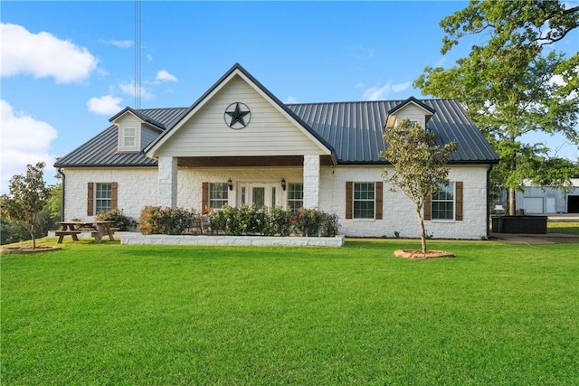 740 Bridget Ave, Buffalo, TX 75831 - view of front of house featuring a front yard, a metal roof, and stone siding
