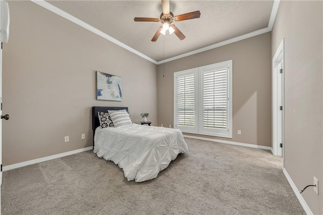 carpeted bedroom with ceiling fan and ornamental molding