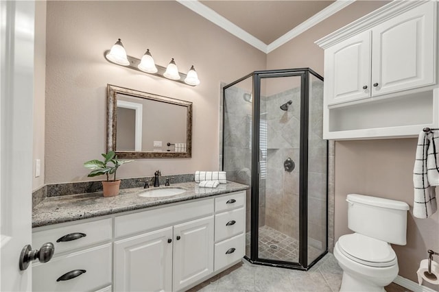 bathroom with vanity, toilet, an enclosed shower, and crown molding