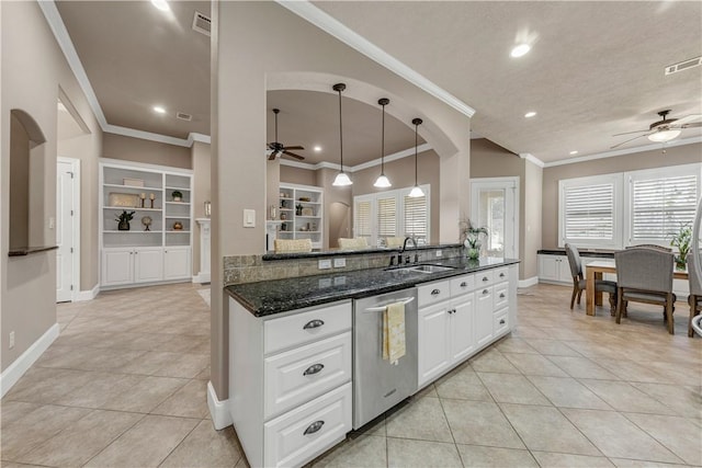 kitchen featuring white cabinetry, dishwasher, sink, dark stone countertops, and decorative light fixtures