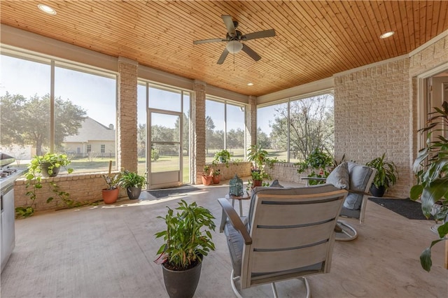 sunroom / solarium with plenty of natural light, wooden ceiling, and ceiling fan