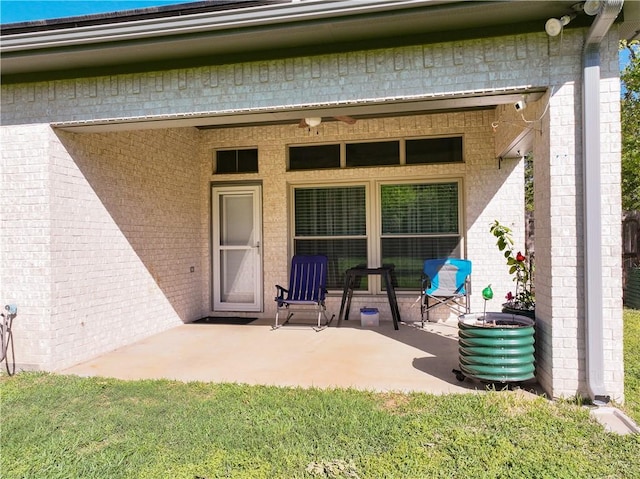 property entrance featuring a patio and a lawn