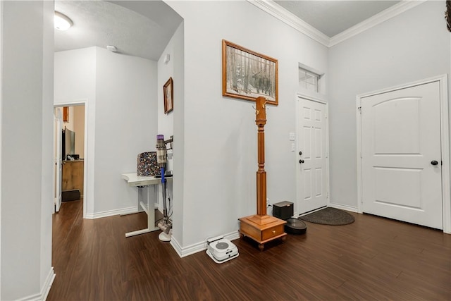 foyer with ornamental molding and dark hardwood / wood-style floors