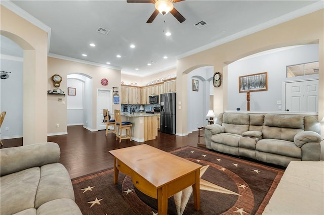 living room featuring ornamental molding, dark wood-type flooring, sink, and ceiling fan