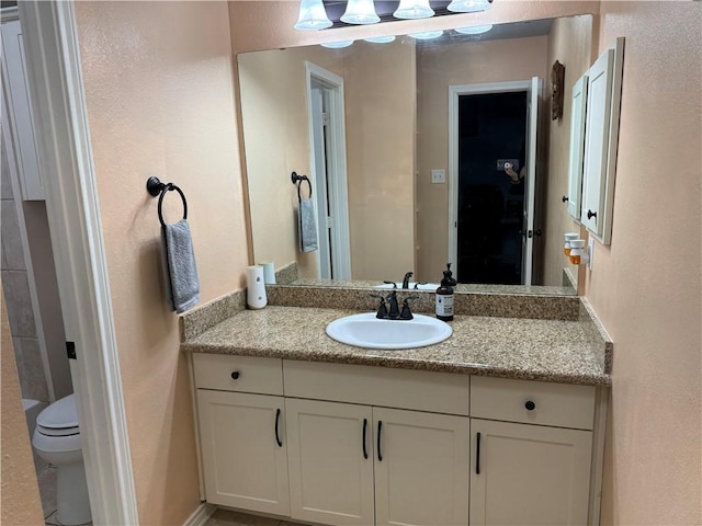 bathroom with vanity and toilet