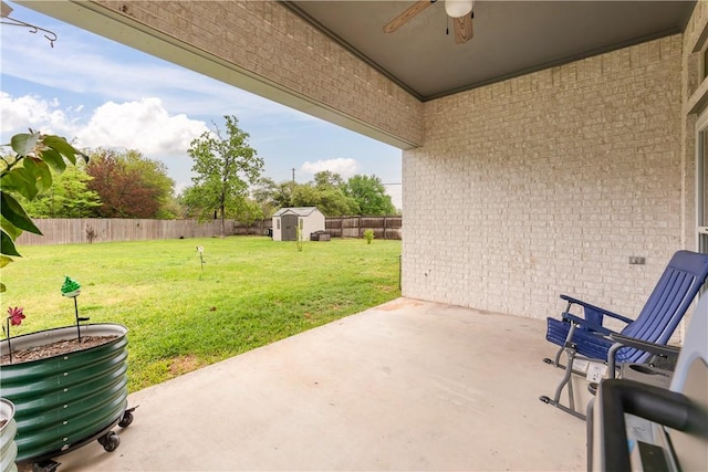 view of patio featuring ceiling fan and a shed