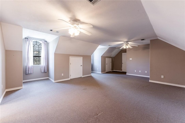 additional living space with ceiling fan, vaulted ceiling, and carpet flooring