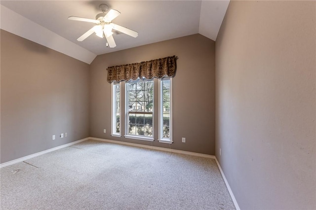 spare room featuring lofted ceiling, ceiling fan, and carpet