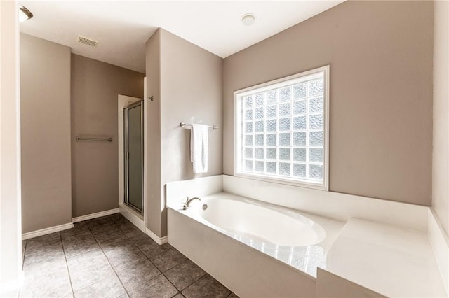 bathroom featuring tile patterned flooring and shower with separate bathtub