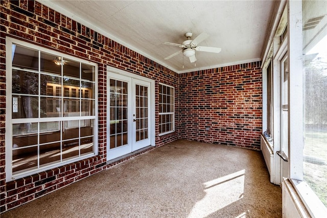 unfurnished sunroom with ceiling fan and french doors