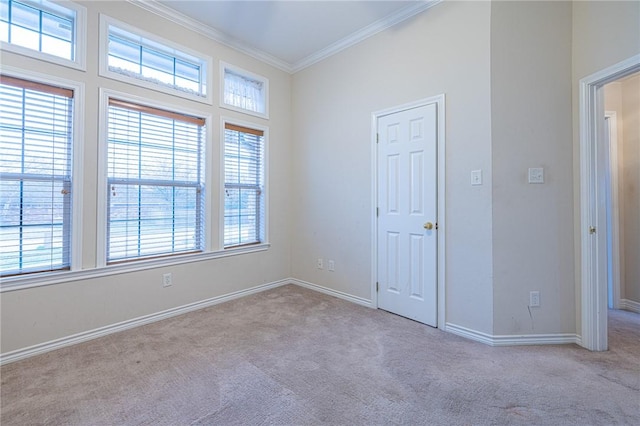 unfurnished room featuring light carpet and crown molding