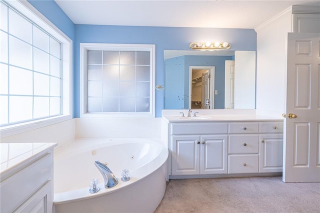 bathroom with a tub to relax in and vanity