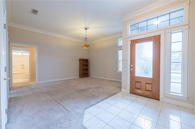 entrance foyer with crown molding, light colored carpet, and a healthy amount of sunlight