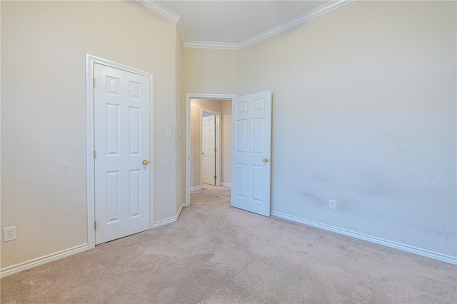 carpeted empty room with crown molding and a towering ceiling